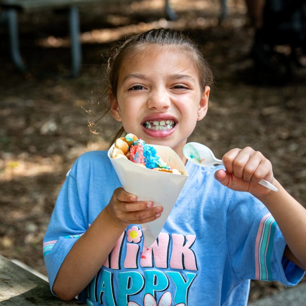 Young girl eating from a bubble waffle ice cream cone