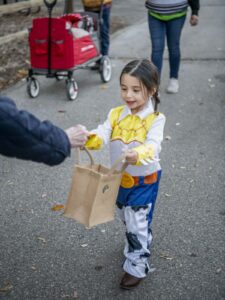 Young girl dressed in costume while trick or treating