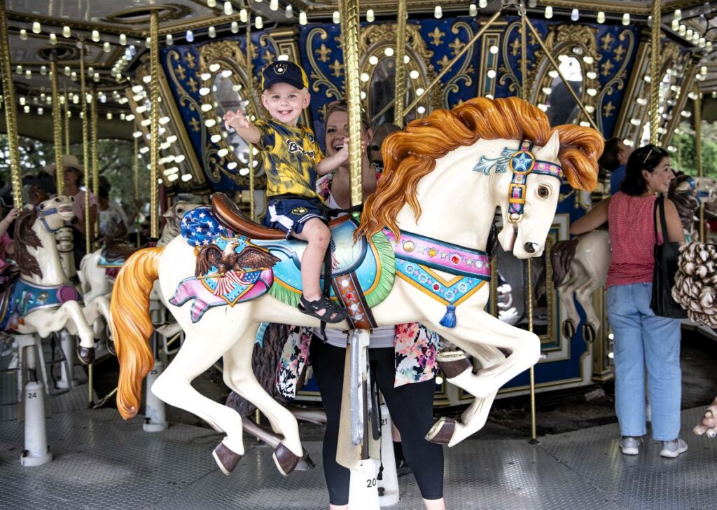 Mother and young son riding the carousel