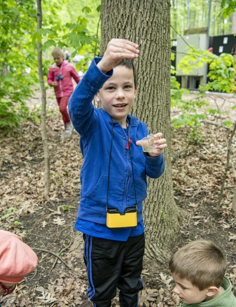 Children exploring the forested area of the Zoo