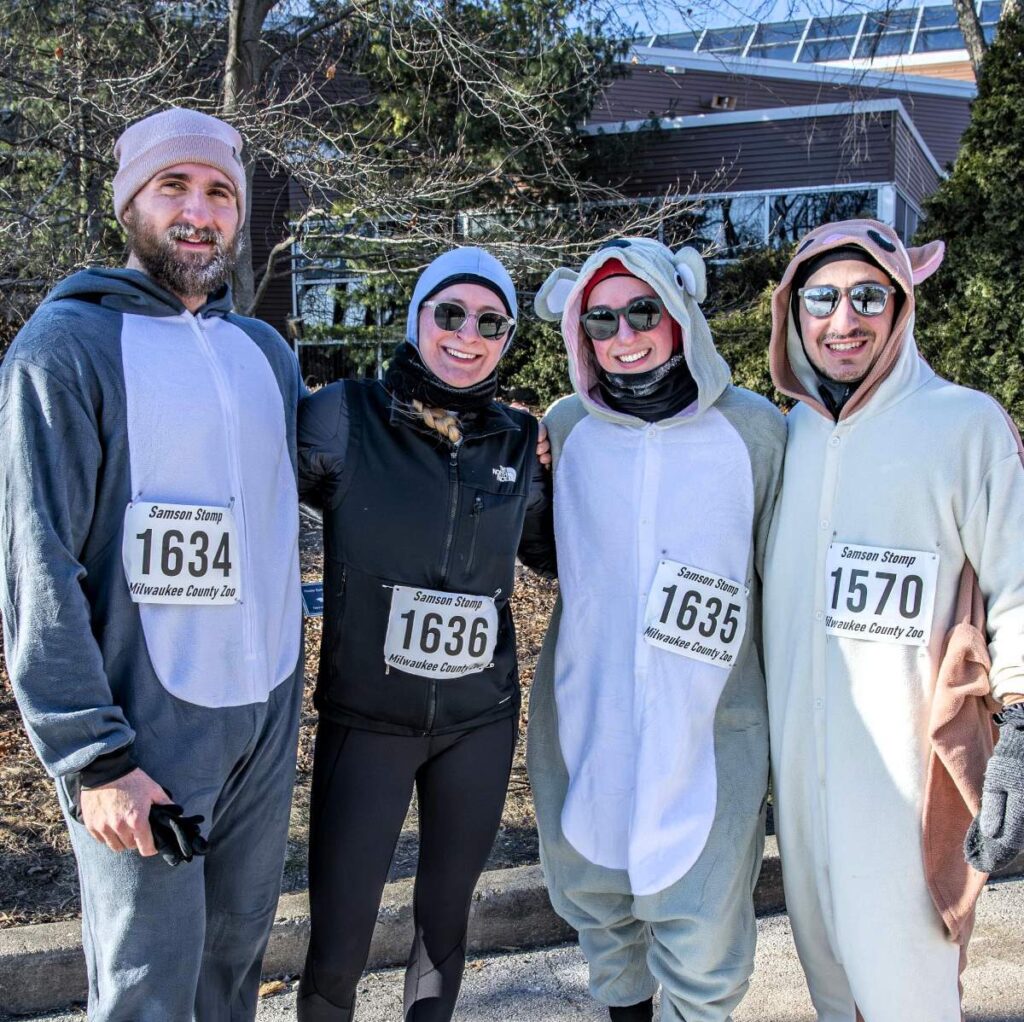 Group of runners wearing animal onesies
