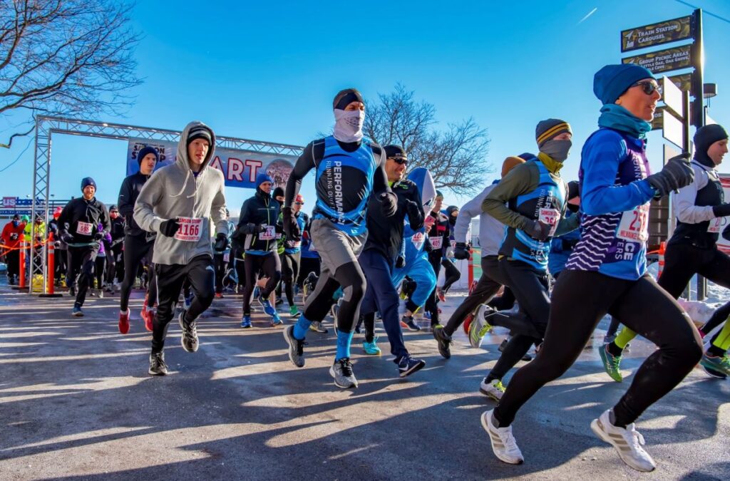 Runners crossing the start line of the Samson Stomp