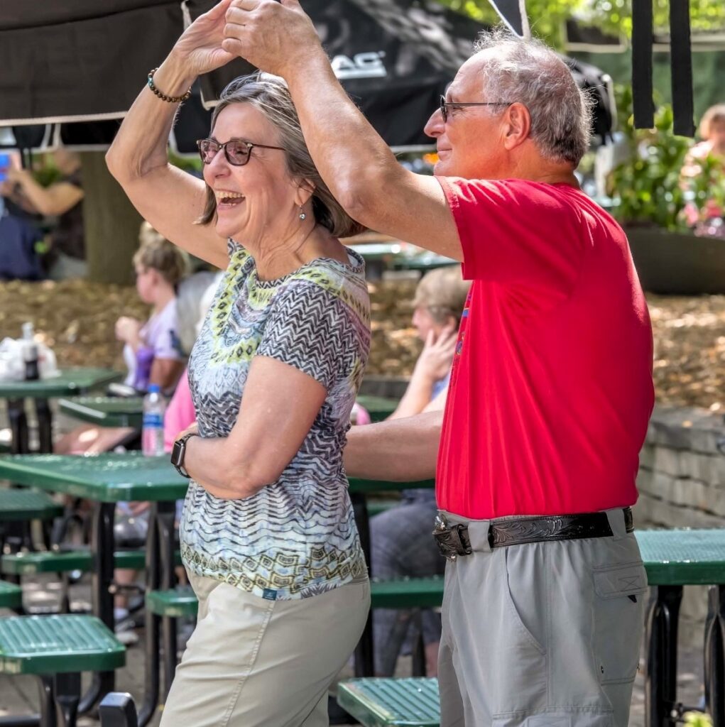 Senior couple dancing outside at the Zoo