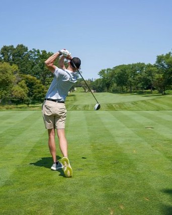 Golfer taking a swing on a golf course