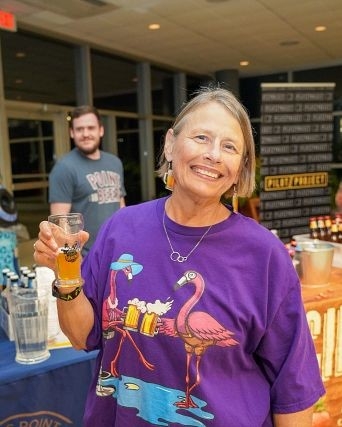 Zoo Brew guest holding a glass of beer